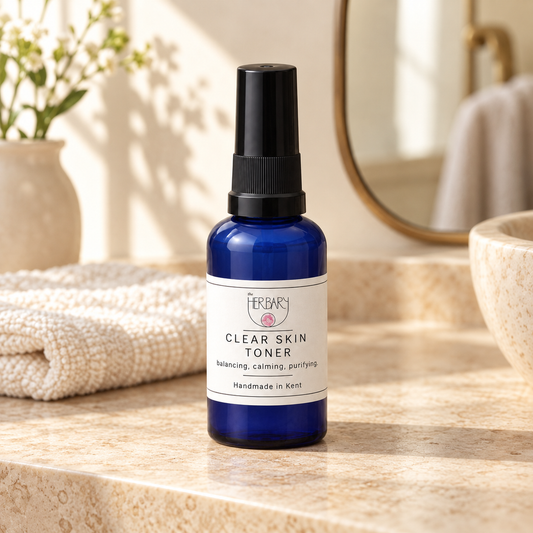 Clear Skin Toner on a warm stone bathroom vanity — The Herbary