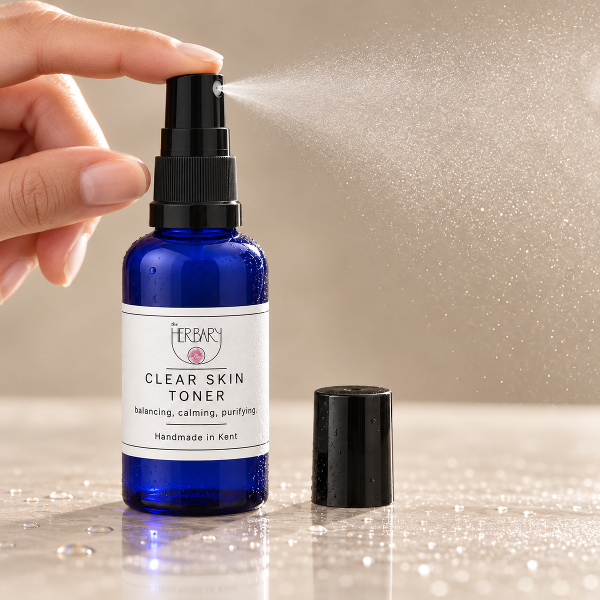 Close-up of Clear Skin Toner releasing a fine mist — The Herbary