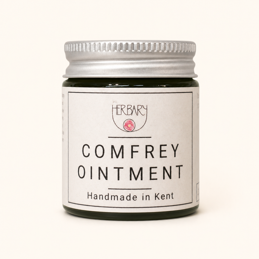 Comfrey Ointment — clean product shot on warm cream