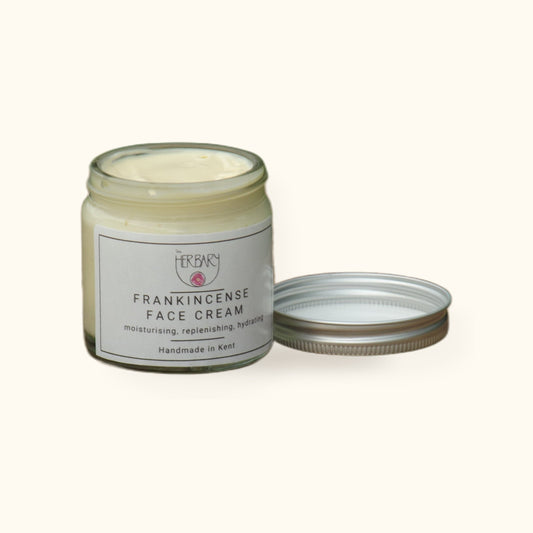 Frankincense Face Cream on cream background with shadow