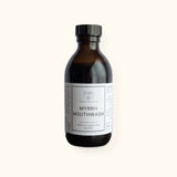 Myrrh Mouthwash on cream background with shadow