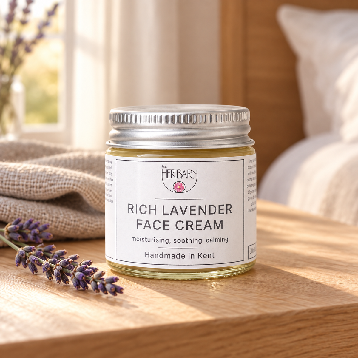 Rich Lavender Face Cream beside lavender on a bedside table — The Herbary