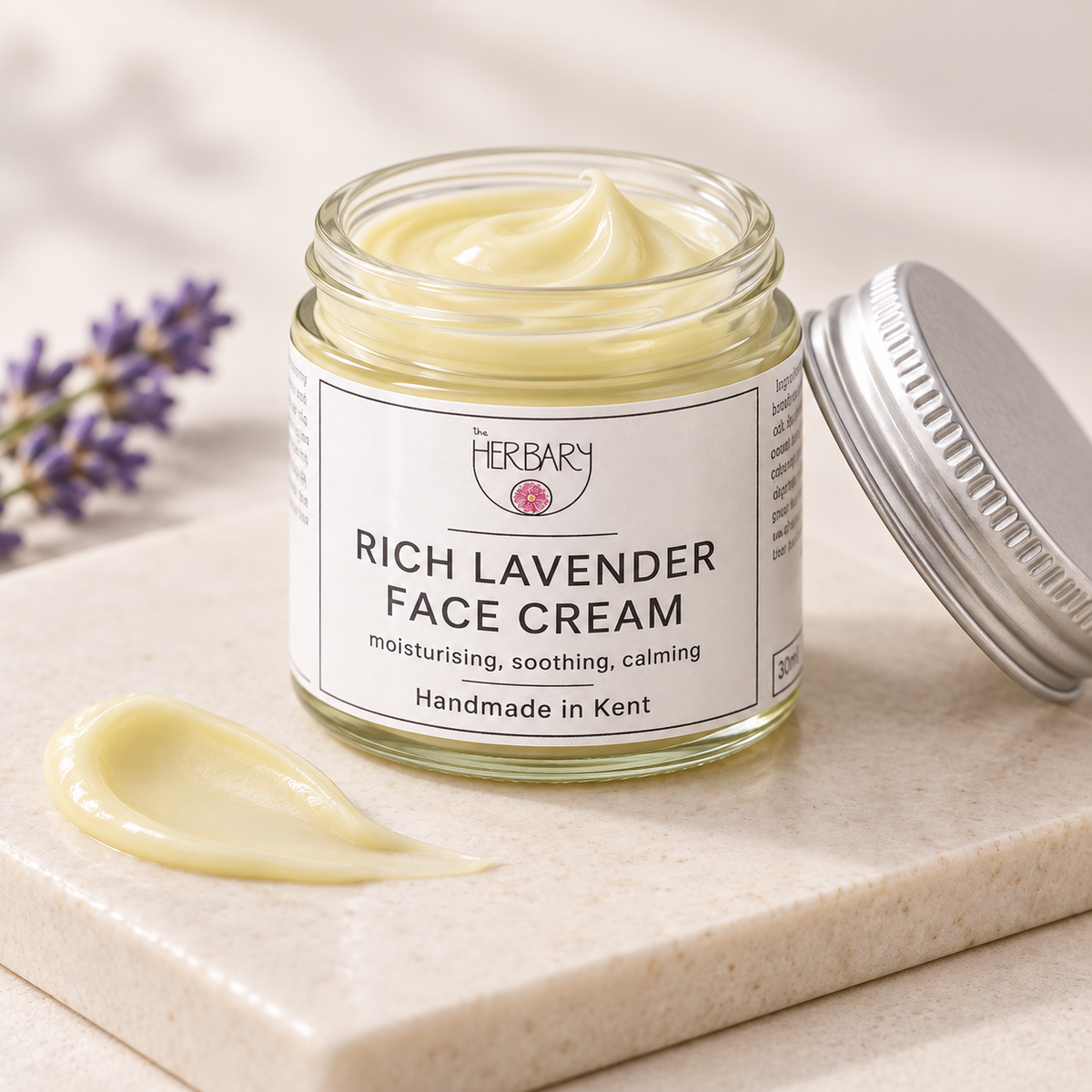 Open Rich Lavender Face Cream jar with a cream texture swatch — The Herbary