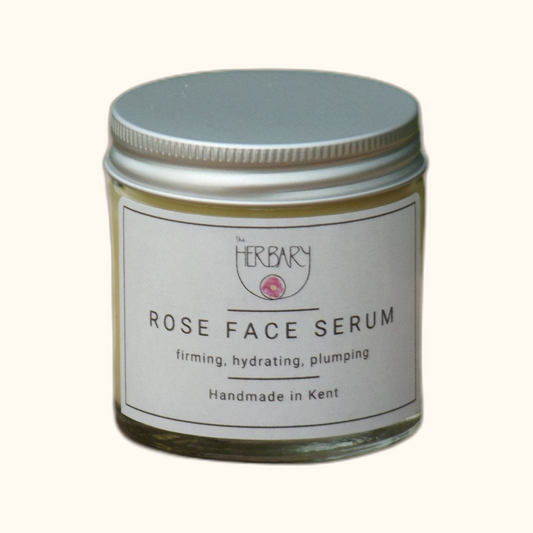 Rose Face Serum on clear cream background