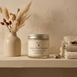 The Herbary Rose Face Serum jar beside dried botanicals and folded linen